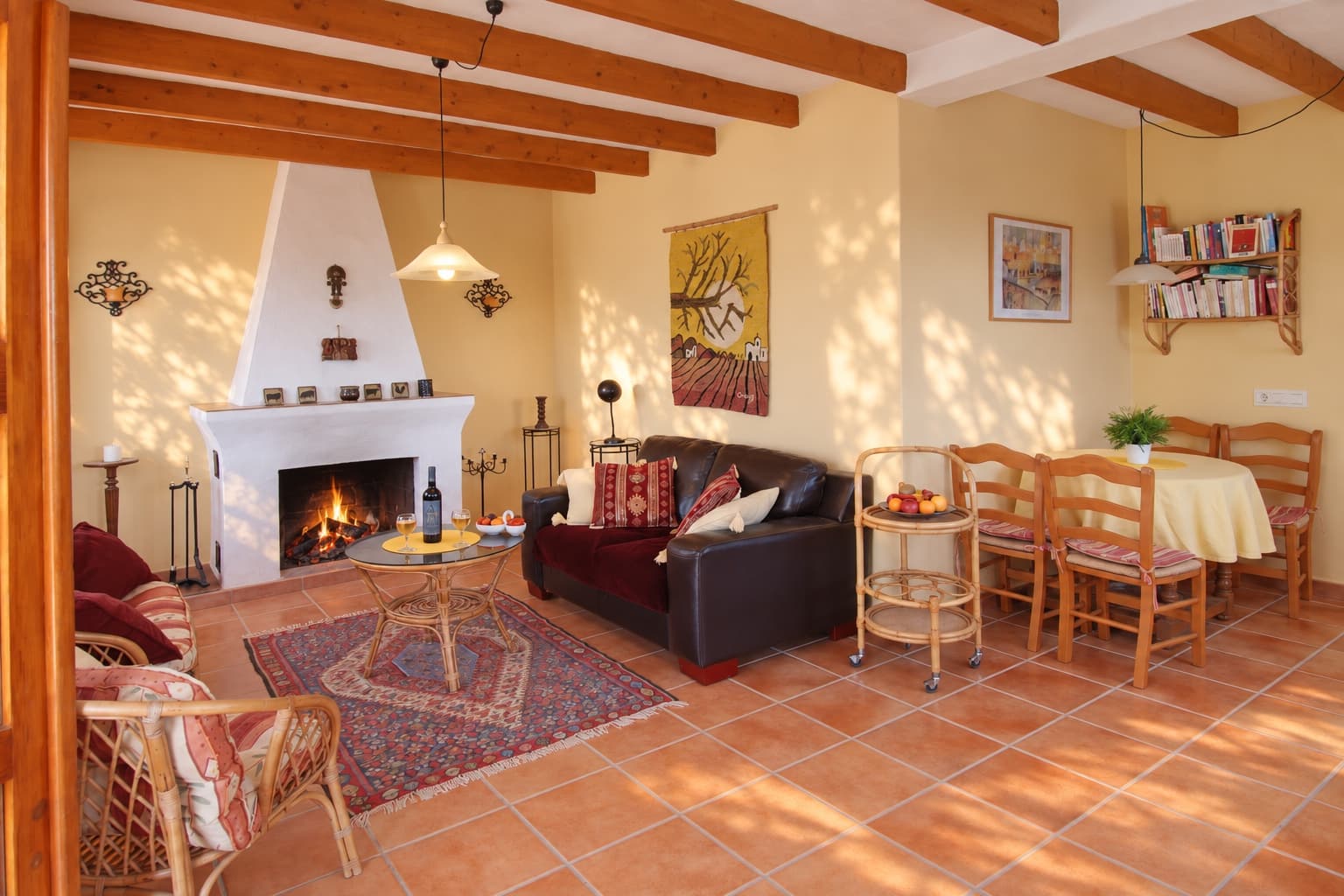 The fireplace, with the dining table beyond.