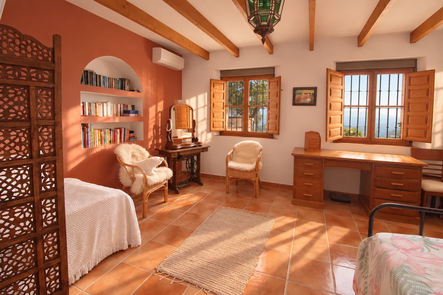The writing desk, with the single beds behind the screen.